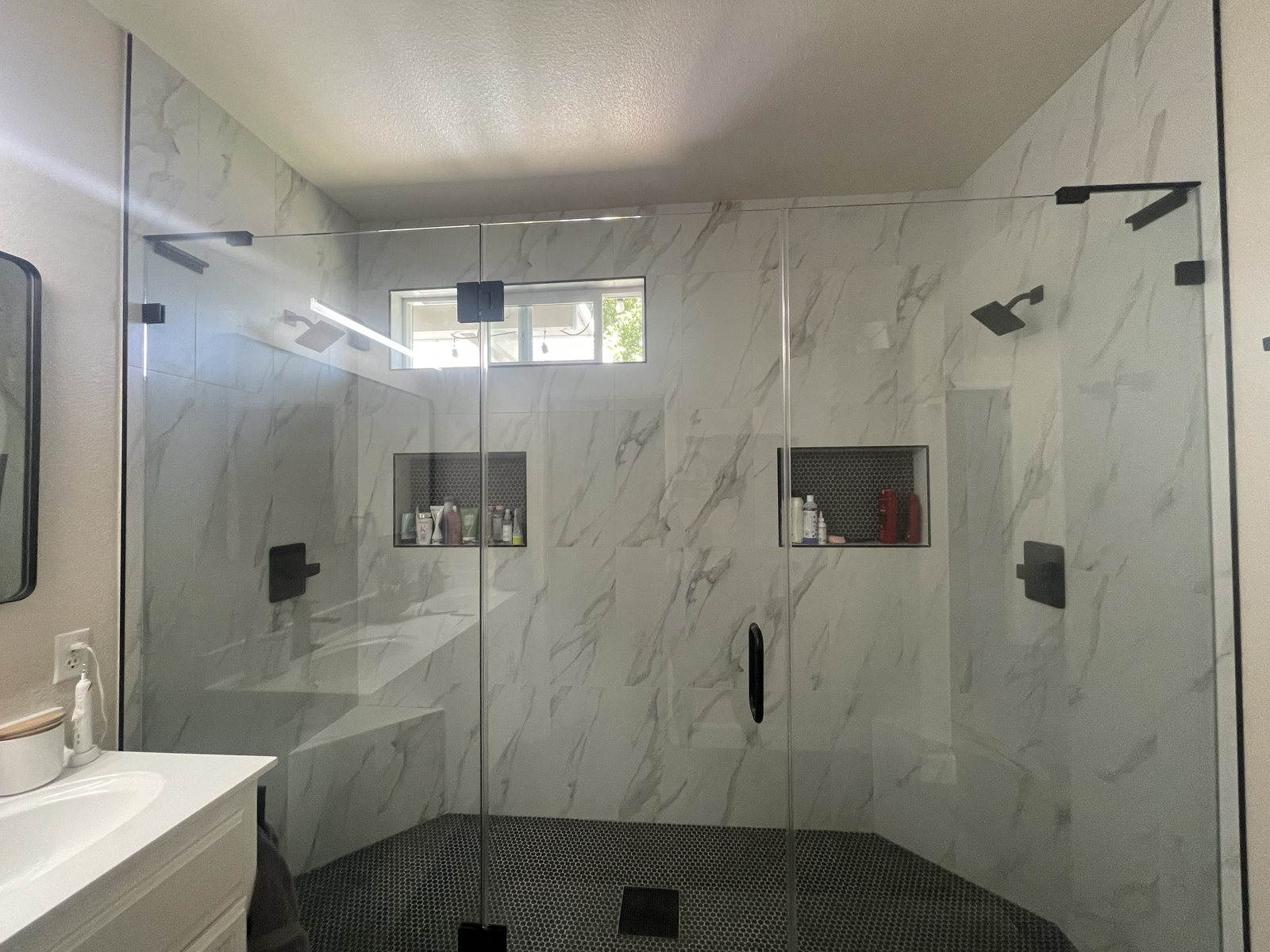 A large walk-in shower with glass doors