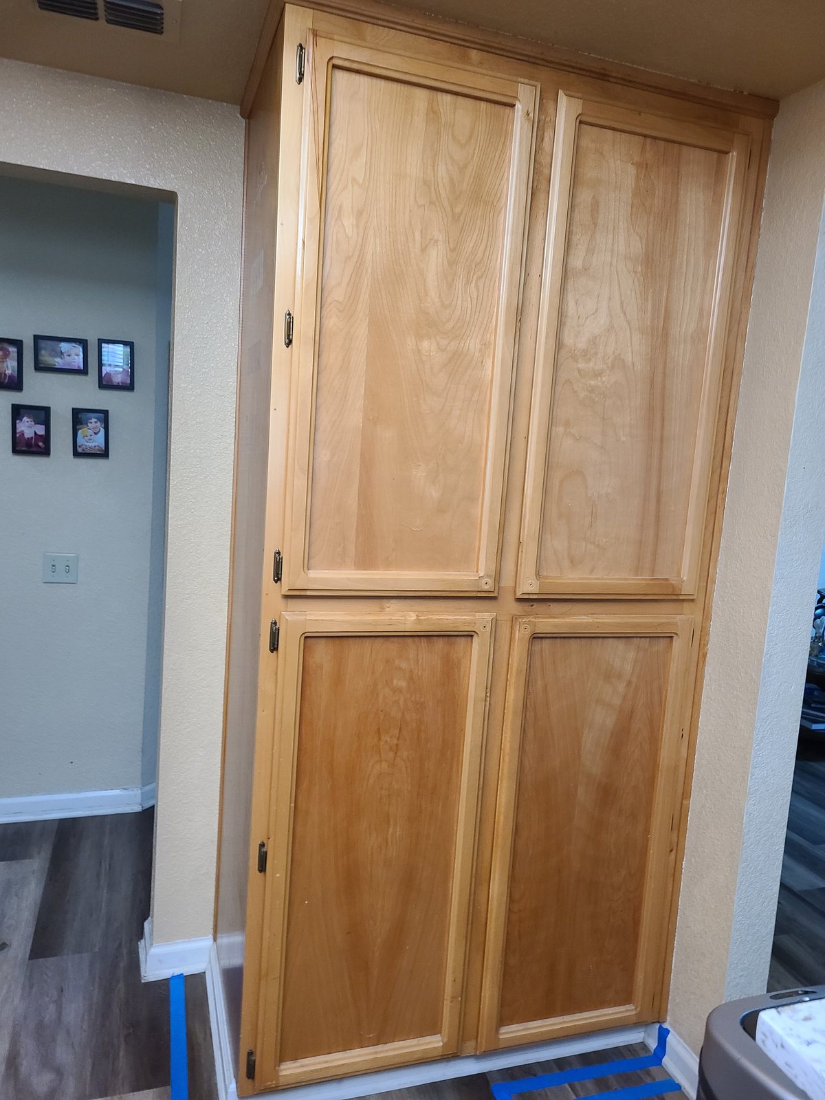 An unfinished wooden pantry cabinet