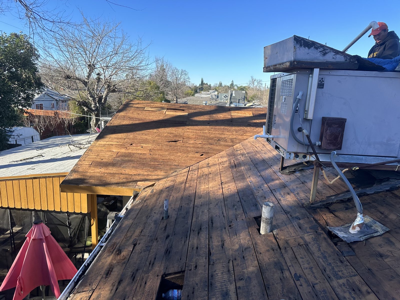 A bare roof deck with roofing materials