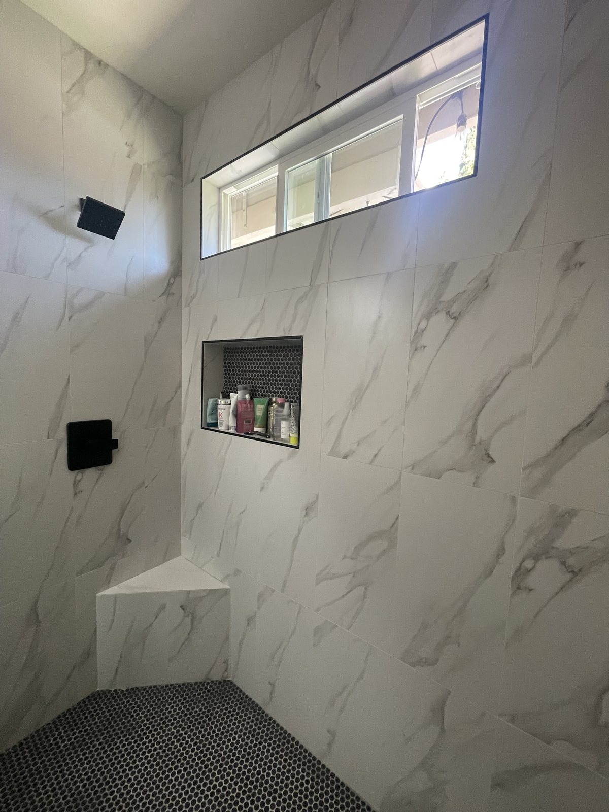 A shower niche with marble-look tile