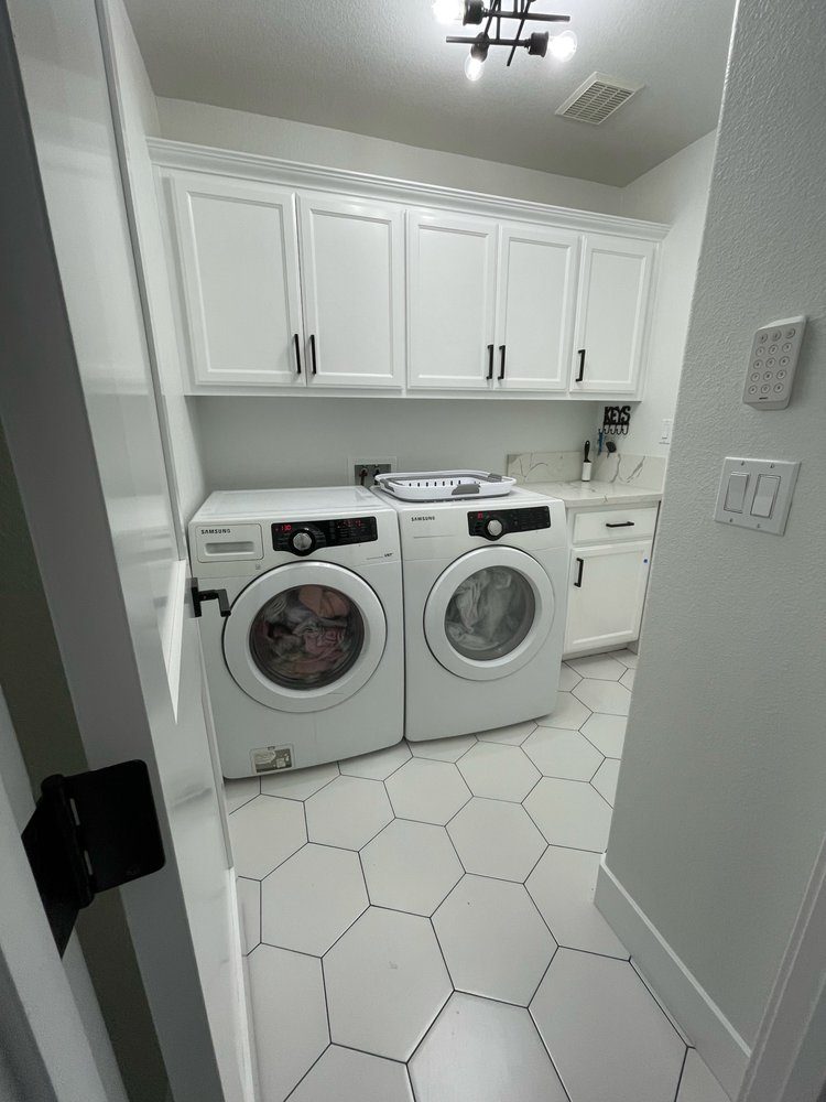 Laundry room: cabinets, counter, lighting and tile